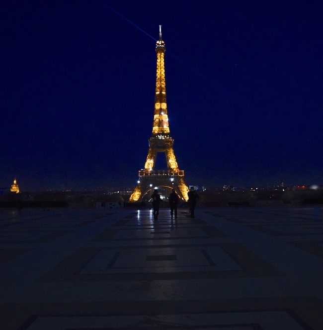 Only a lone police patrol in front of the Eiffel Tower
