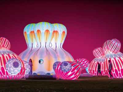 Multiple large pink and blue inflatables with neon colours