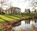 Maison Derain landscape photo with trees and a lake
