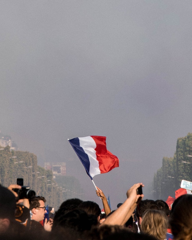 Protestors Raising the Blue, Red, and White Flag