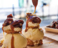 Bourbon vanilla ice cream from Madagascar with vanilla whipped cream, topped with fleur de sel caramel sauce and caramelized pecans.