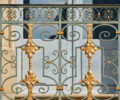 Ornamental ironwork along rear entrance of château.