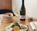 A dish at Pianovins with wine on the side