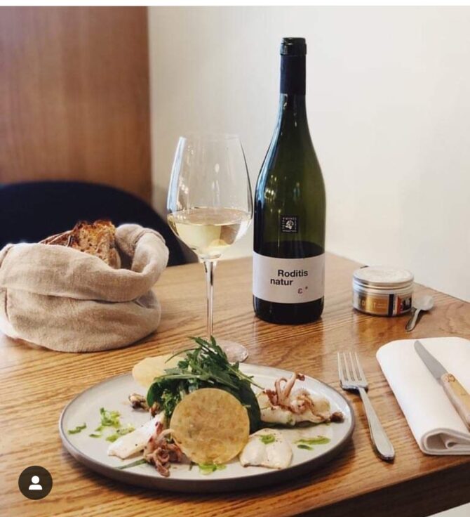 A dish at Pianovins with wine on the side